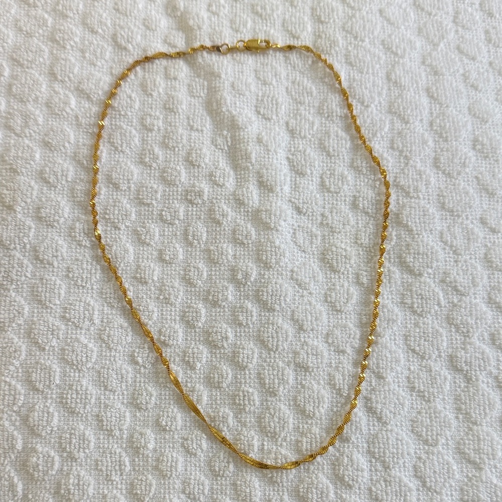 Gold tone twisted look necklace. New in bag